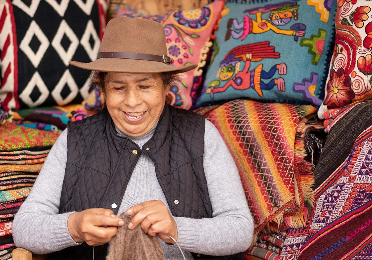 Man knitting and smiling